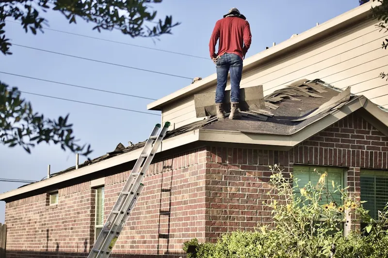 Professional roofer working on a residential roof in Morgansburg